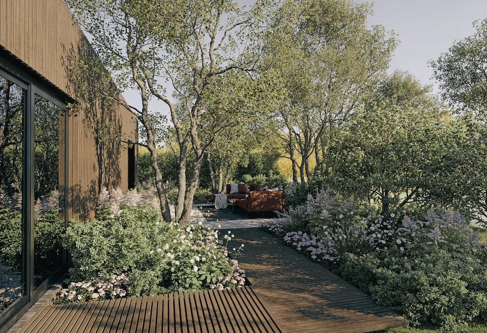 Holzsteg mit Feinsteinterrasse umgeben von üppiger Bepflanzung